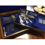 An oak cased canteen dated 1904 containing silver plated cutlery, the baize lined interior with tray