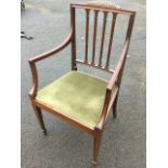 A mahogany open armchair with moulded back frame and arms having applied leaf carved crest above