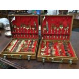 Two cased sets of eastern brass cutlery, the boxes each with trays, the pieces having embossed