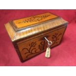 A nineteenth century satinwood tea caddy of tapering sarcophagus shape, inlaid with walnut anthemion
