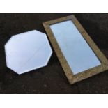 A rectangular floral embossed brass framed mirror with bevelled plate; and an octagonal frameless