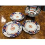 A set of three nineteenth century Japanese plates painted with central leaf medallions framed by