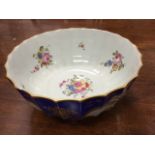 A large scalloped Rockingham style bowl having exterior painted with polychrome vases of flowers