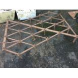 An old harrow, the diamond grid frame having two hooked drawing mounts, with 24 square pointed