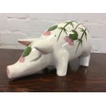 A Plitcha Wemyss style porcelain pig with snout to ground, handpainted with thistles, the rump