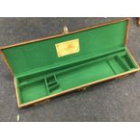 An Army & Navy gun case, the fitted box with baize lining having brass & leather mounts. (30in)