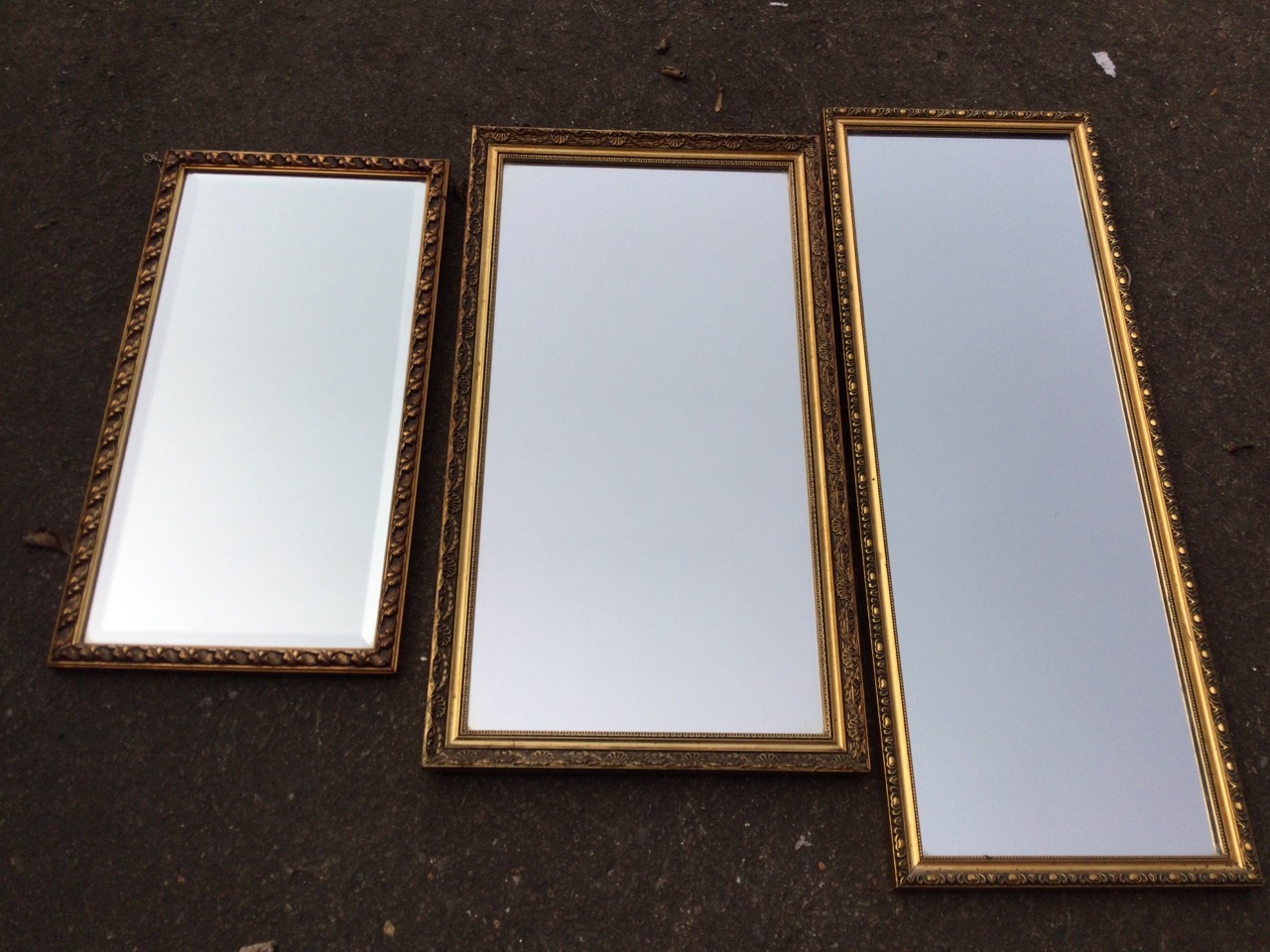 Three rectangular mirrors with foliate moulded gilt frames, one with bevelled plate. (3)