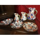 A set of three nineteenth century graduated Masons Ironstone octagonal jugs with serpent handles;