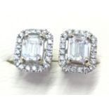 A pair of 18ct white gold diamond cluster earrings, the emerald cut diamonds weighing over a