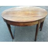 A nineteenth century mahogany dining table in two D shaped halves forming a circular top, with plain