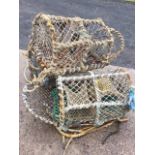 Three lobster pots with arched metal frames having drop-down ends, each with three apertures. (3)