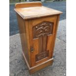 An art nouveau mahogany pot cupboard with moulded top above a scroll carved panelled door mounted