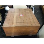 A heavy C20th Japanese Shogi board, the heavy block with divisioned top on octagonal fluted