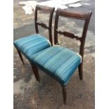 A pair of nineteenth century mahogany chairs with tablet panelled back rails on ribbed stiles, the