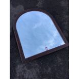 An arch shaped mirror in stained frame. (23.5in x 39.75in)