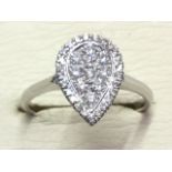 A 18ct diamond ring, the pear shaped panel pave set with diamonds weighing just under half a