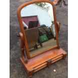 A Victorian mahogany dressing table mirror, the arched plate in cushion moulded frame on shaped
