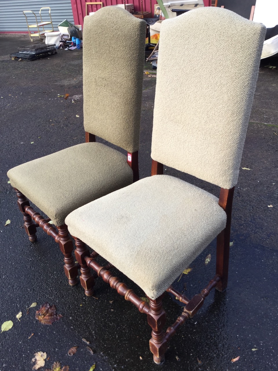 A pair of Queen Anne style upholstered hall chairs, with tall arched backs above sprung seats,