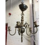 A brass hanging light with column suspended by rod from cup ceiling rose, having five scrolled