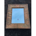 A contemporary rectangular mirror, the bevelled plate in panelled patinated stepped copper frame. (