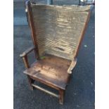 A nineteenth century pine Orkney armchair, the rounded back in rectangular frame with scroll