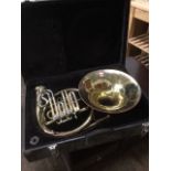 A cased brass French horn - A/F.