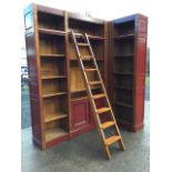 A large French oak library bookcase, with panelled back and adjustable shelves above cupboards,