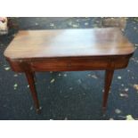 A nineteenth mahogany turn-over-top tea table, with rounded twin leaves above an ebony strung frieze