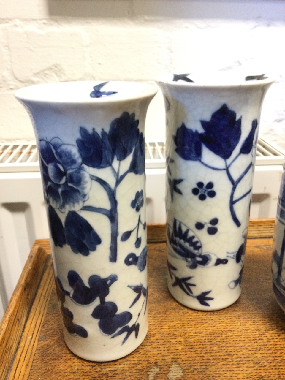 A pair of Japanese tubular vases with flared rims painted with birds, butterflies and prunus blossom - Image 2 of 3