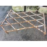 An old harrow, the diamond shaped grid having 24 spikes, with two drawing hooks - make excellent peg