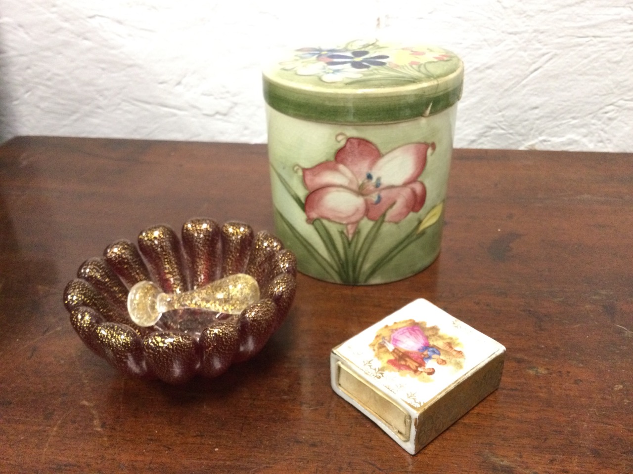 A Moorcroft tube lined floral jar & cover - lid repaired; a porcelain matchbox cover decorated