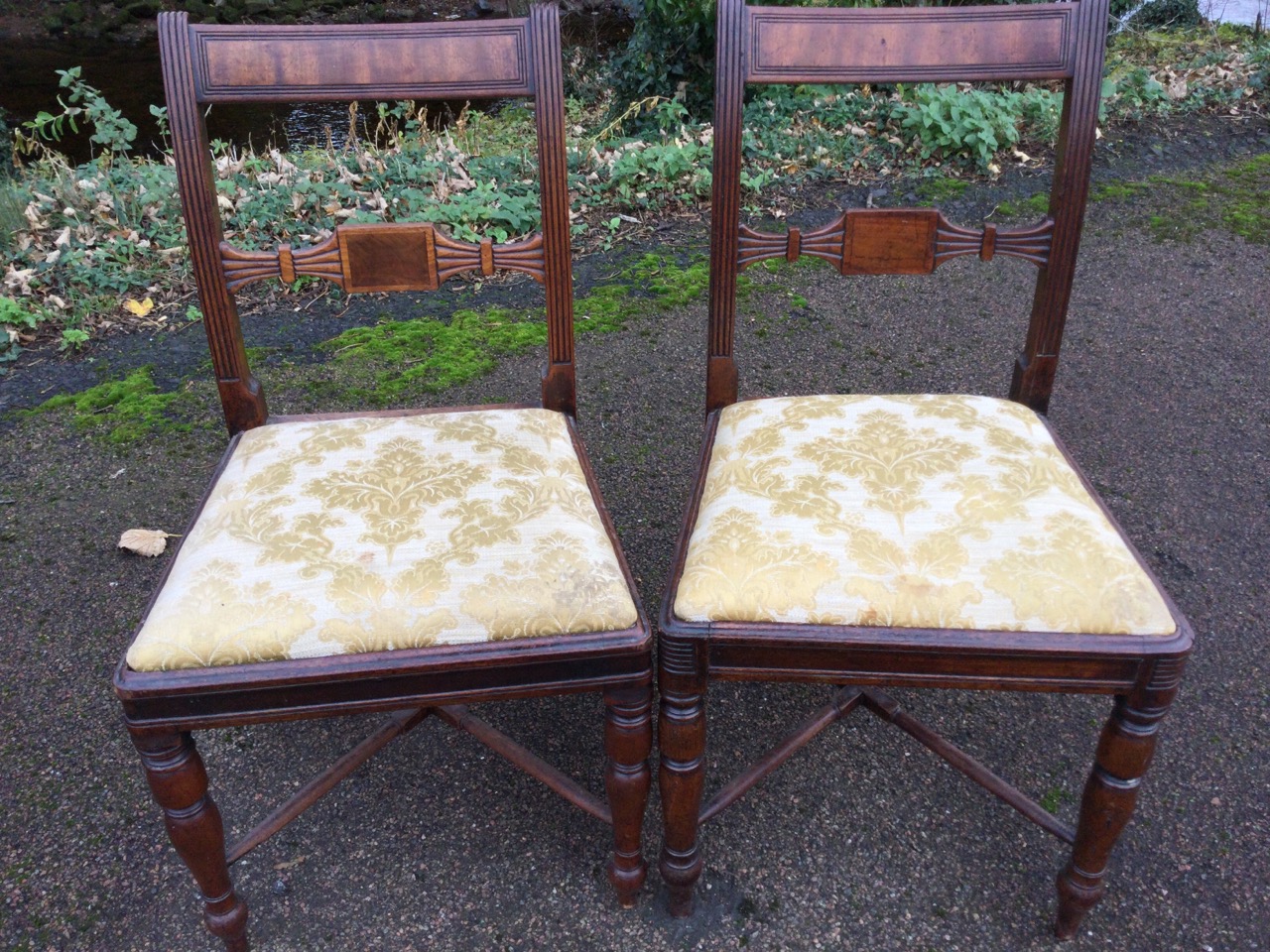 A near pair of nineteenth century mahogany dining chairs with tablet back rails framed by fluted