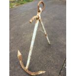 A cast iron ships anchor mounted with ring to shaft. (40in)