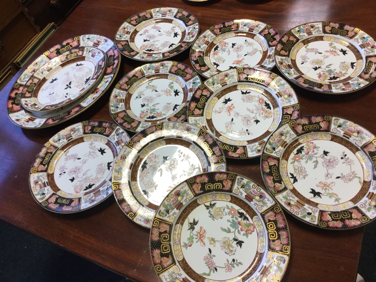 A set of Victorian Ashworth real ironstone plates and two graduated ashets, the pieces decorated