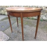 A 'D' shaped mahogany turn-over-top tea table, the twin flaps above a frieze with small knobbed