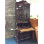 An Edwardian mahogany bureau bookcase with arched moulded cornice above astragal glazed doors