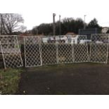 A set of six rectangular wrought iron panels, with waved oval scalloped grills in metal frames. (