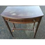 An Edwardian bowfronted mahogany side table, the reeded top above a frieze drawer raised on square
