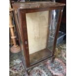 A wanut display cabinet with shaped top above a rectangular glass door, raised on cabriole legs. (