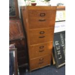 A large wood filing cabinet, the four drawers mounted with metal handles and label holders. (20in