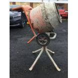 A Belle Group electric cement mixer with pouring stand, the drum on trolley.