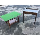 An Edwardian stained oak desk with leatherette skiver to hinged lid, raised on square tapering