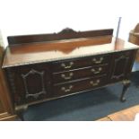 A carved late Victorian mahogany sideboard, the back with scrolled crest above a gadrooned carved