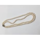 Cultured pearl two strand necklace with two strings of 6.5mm cultured pearls on a silver and garnet