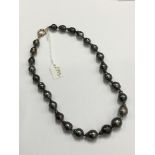 Cultured Tahitian baroque black/grey pearl necklace with a single string of slightly graduated