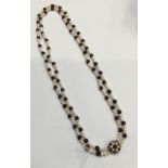 Garnet and cultured pearl necklace with two strings of garnet beads interspaced by cultured