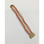 Coral bead and cultured pearl six-strand bracelet with yellow metal clasp. 19cm