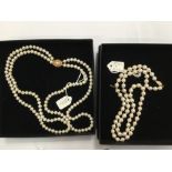 Two cultured pearl necklaces with gold clasps, one with two strands of 5.5-6mm freshwater cultured