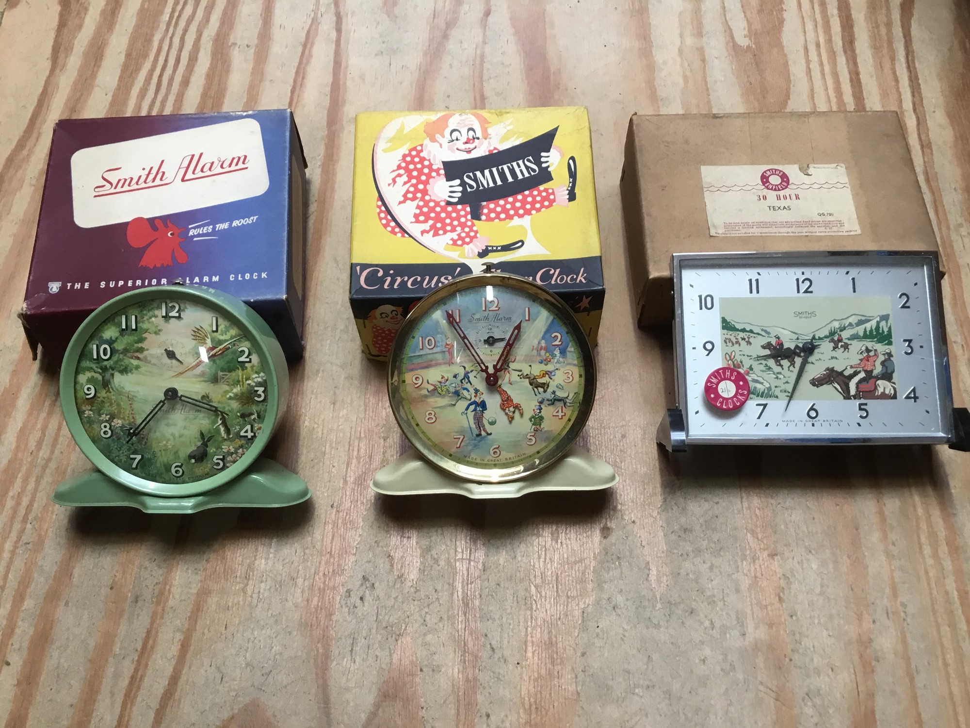 Three vintage Smiths clocks to include ‘Circus’ alarm clock, cowboy and country side scene, all
