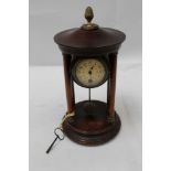 Early 20th Century French mantel clock supported by four pillars with pendulum below